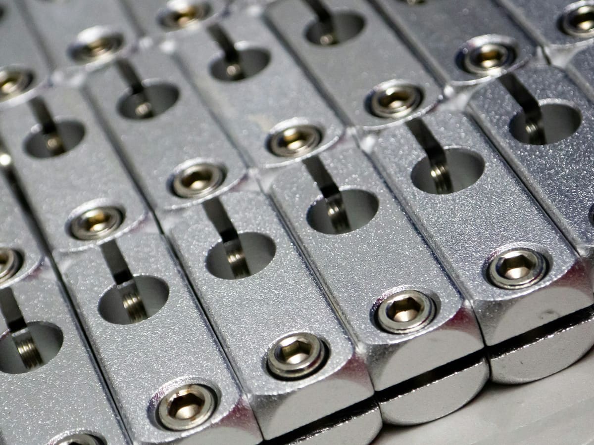 Repeating cylindrical metal parts arranged in a uniform grid