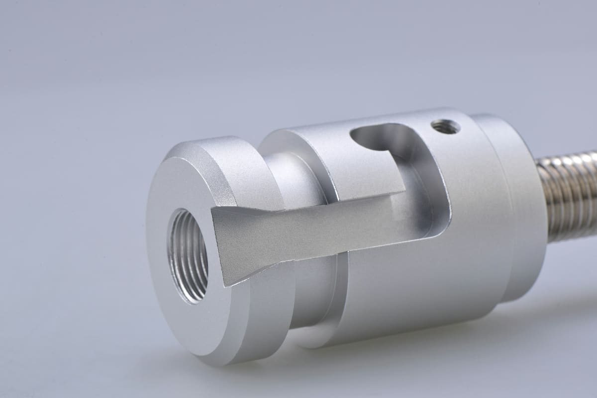 Precision machined cylindrical component photographed against a plain background