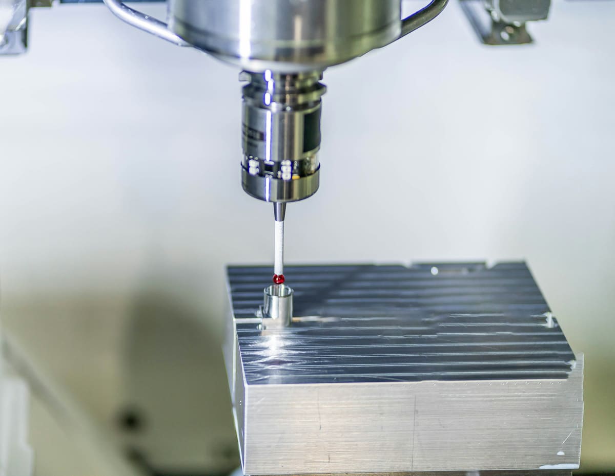 Machine tool cutter working a flat aluminium block under even workshop lighting