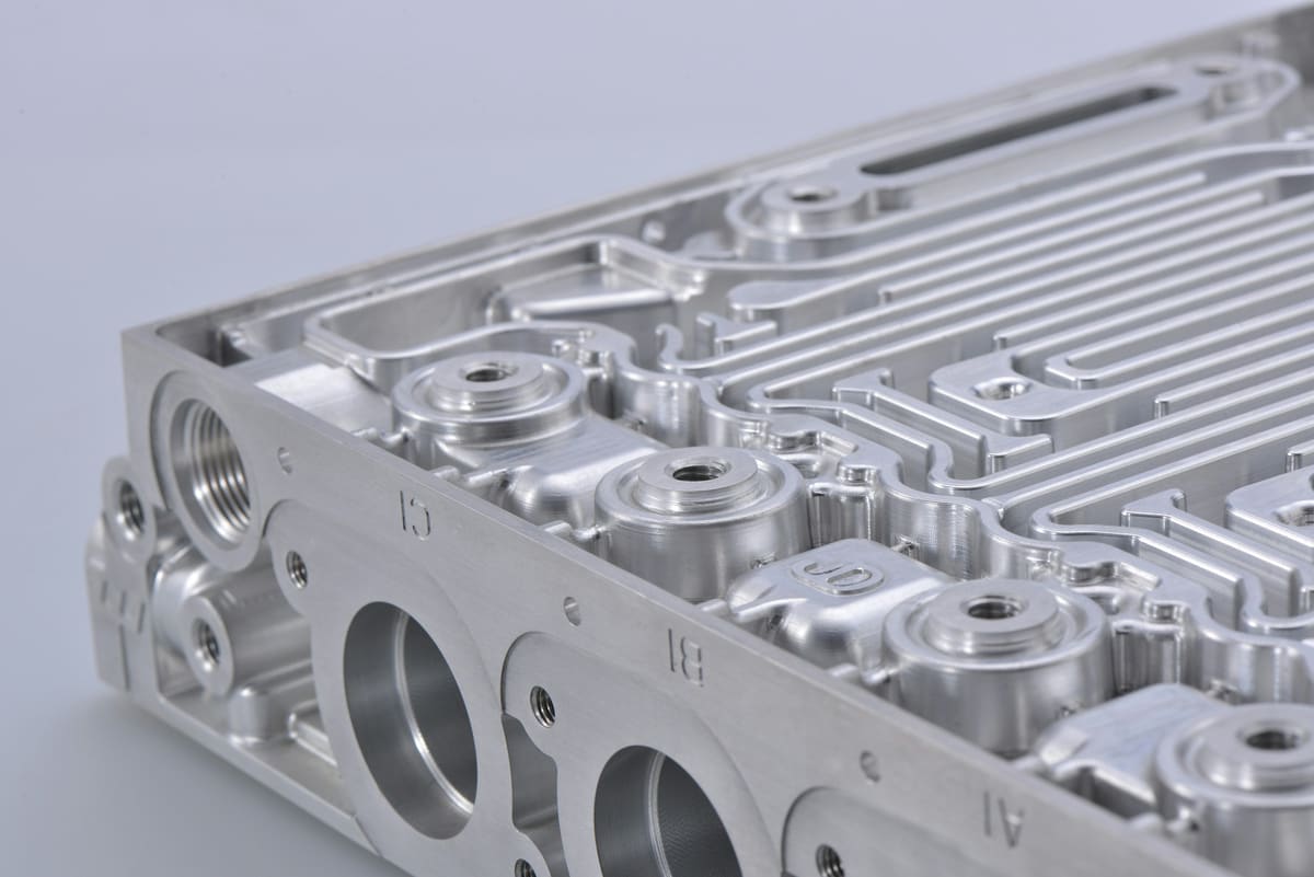 Cast and machined aluminium component showing fabricated detail and finished faces