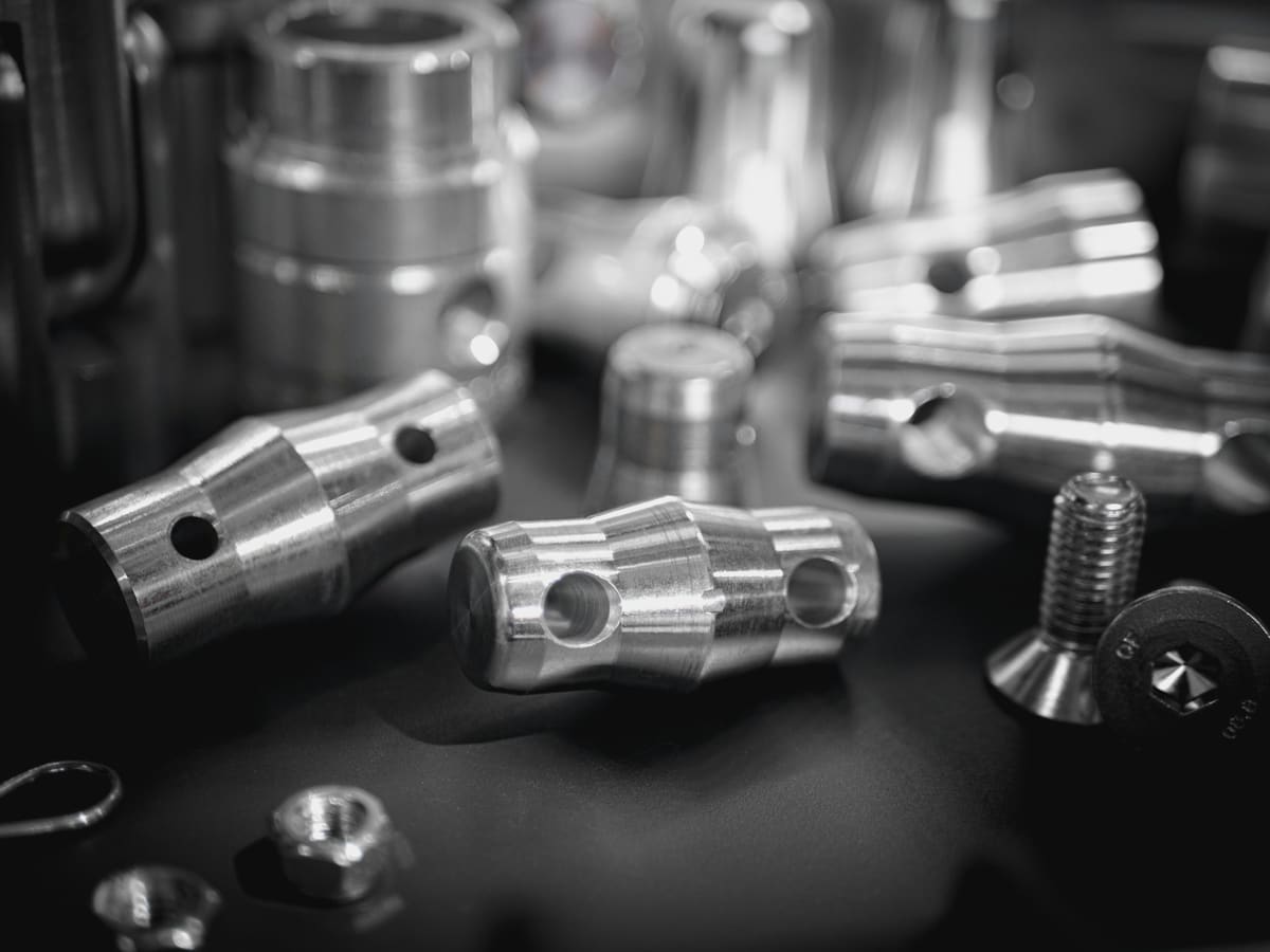 Machined metal parts grouped together in a monochrome engineering study
