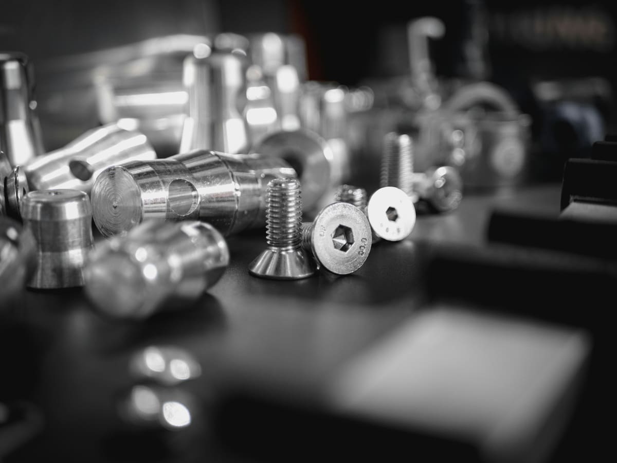 Set of machined steel components arranged in rows for category review