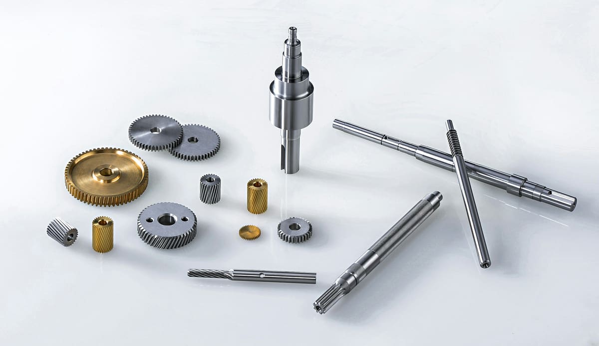 Machining accessories and small tooling components arranged on a white surface